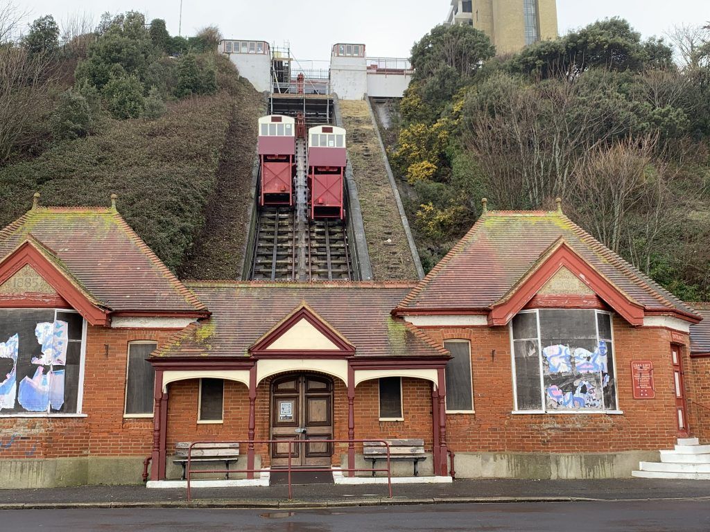 A building with a rail going up a hill with the lift attached