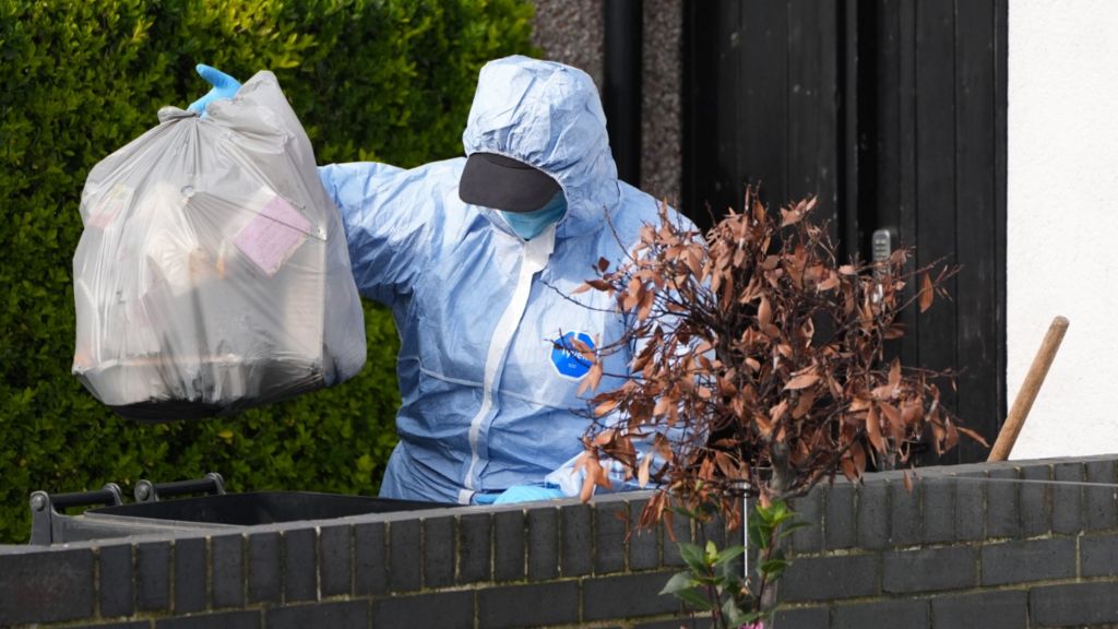 Police in forensic suits spent Monday searching bins, drain pipes and guttering all along Brookside Road in Golders Green
