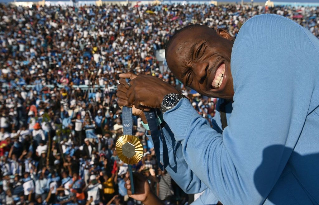  Letsile Tebogo poses with his gold Olympic medal in a stadium in Gaborone, Botswana.