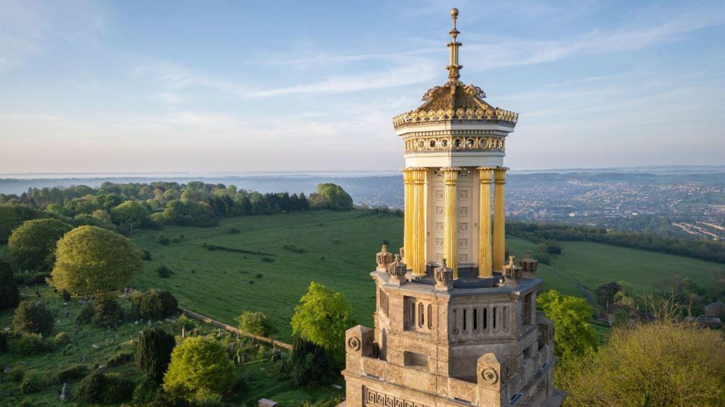 The Beckford Tower near Bath with green fields behind it and a clear blue sky