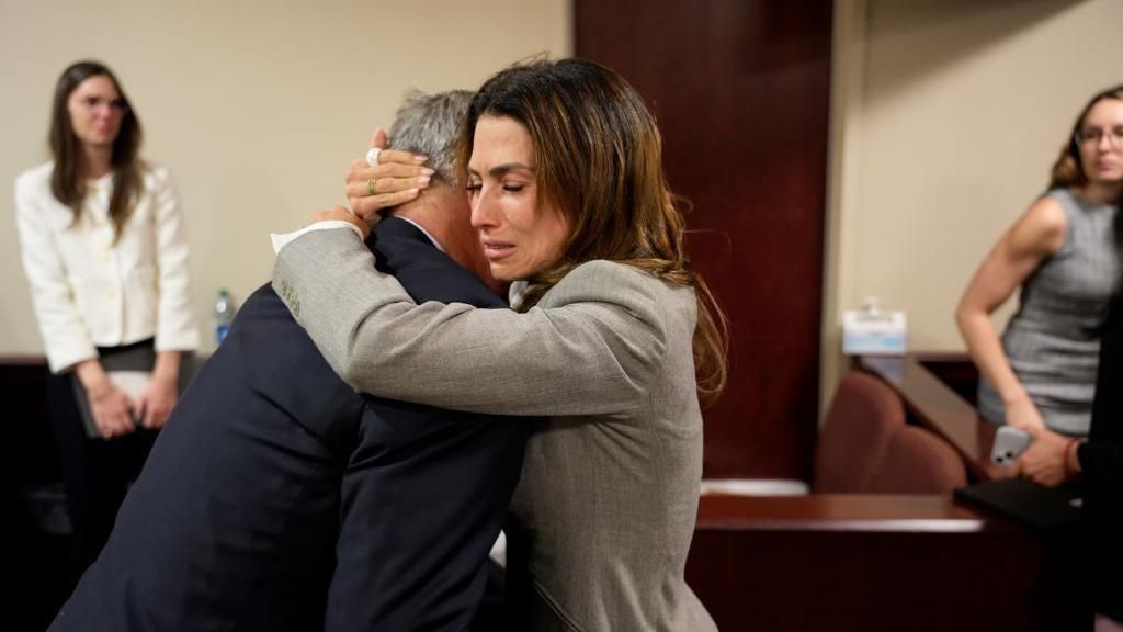 The Baldwins hug in court