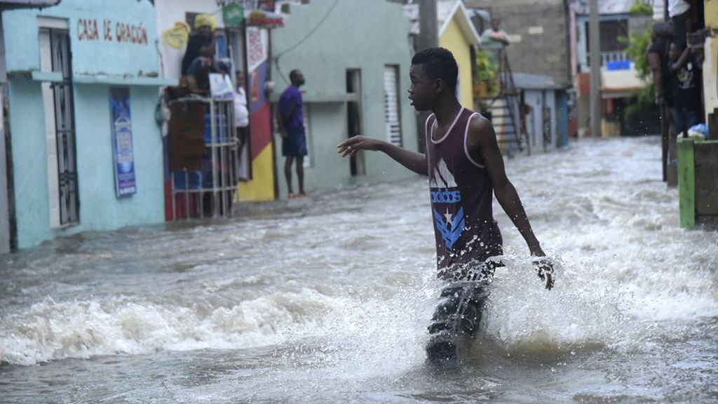 Young man wading through a flooded street