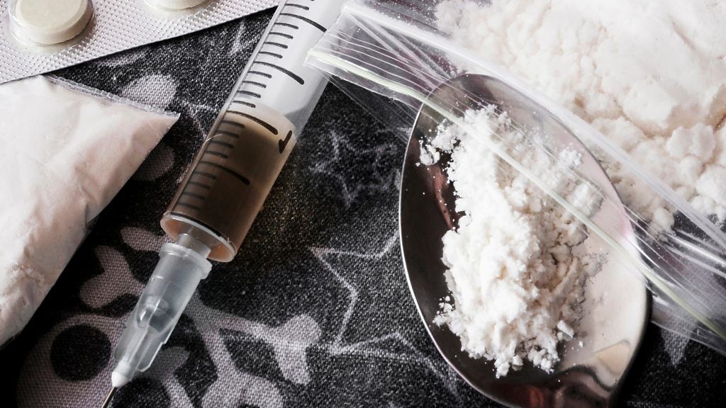 A concept photo of heroin on a spoon and a syringe