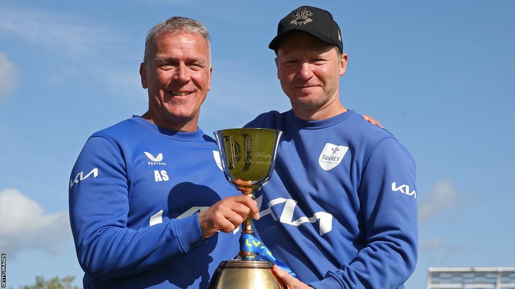 Alec Stewart and Gareth Batty hold the County Championship trophy