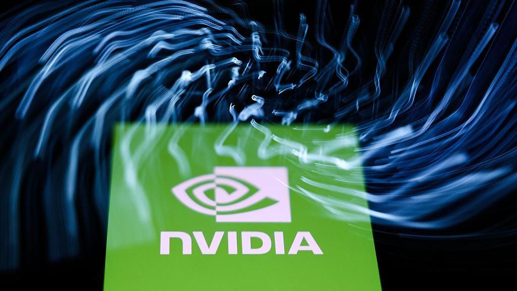 A laptop keyboard and Nvidia logo displayed on a phone screen are seen in this multiple exposure illustration photo