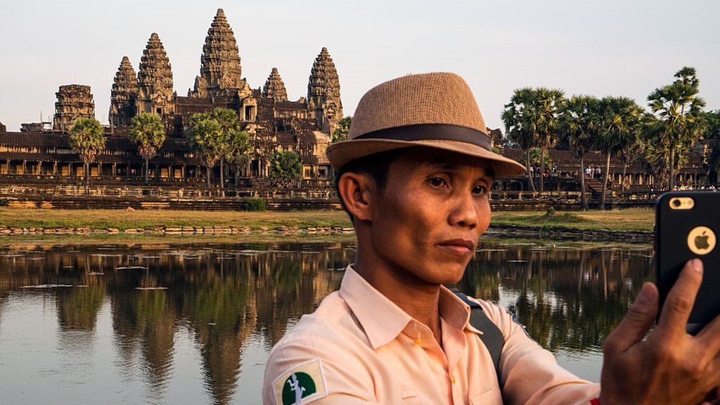 Angkor guide taking a selfie outside Angkor Wat.