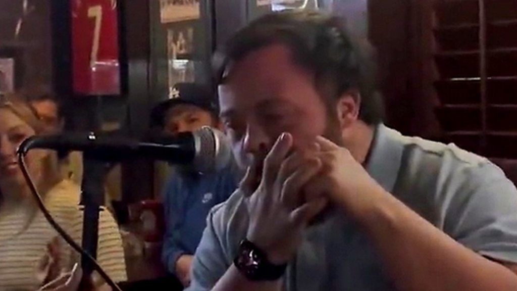 James Martin plays his harmonica in an Irish bar in Los Angeles