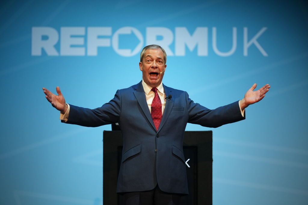Nigel Farage speaks on stage during the Reform UK East Midlands Conference at the Athena Events Venue on 3 January 2025.
