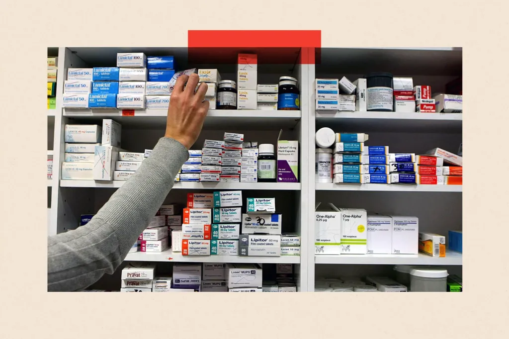 A pharmacist stocks shelves at a chemist.