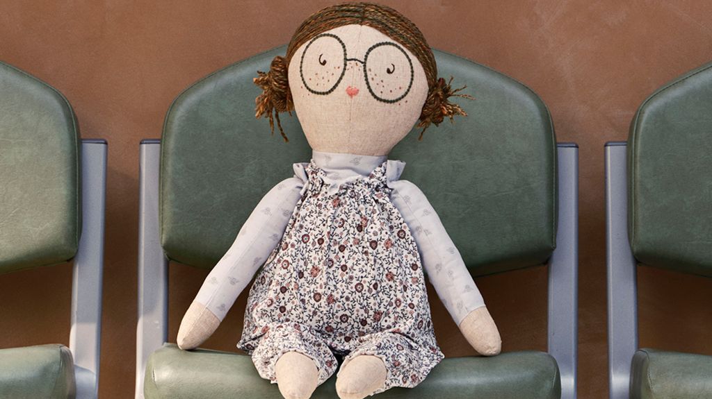 A doll sitting on a hospital chair
