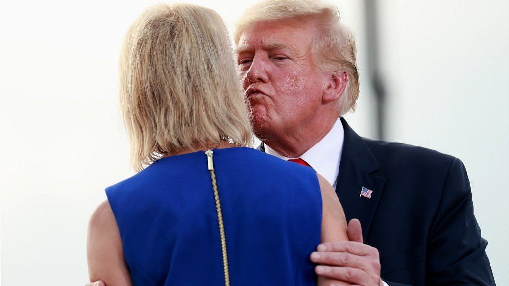 Donald Trump kisses his pick in Republican primary, Mary Miller, on the cheek