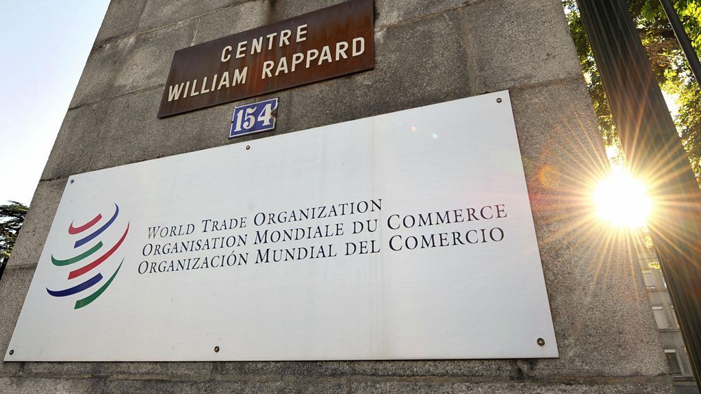 The sun rises at the World Trade Organisation headquarters in Geneva