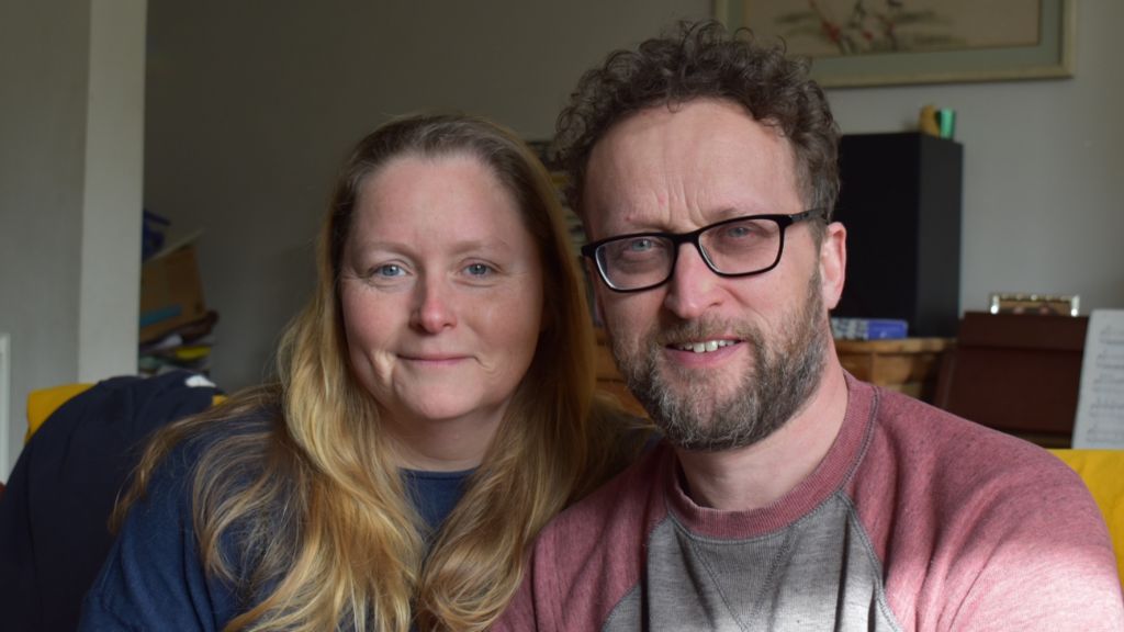 A close-up of Claire and Rob smiling into the camera