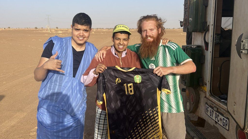 Russ Cook receives a Mauritania shirt from locals