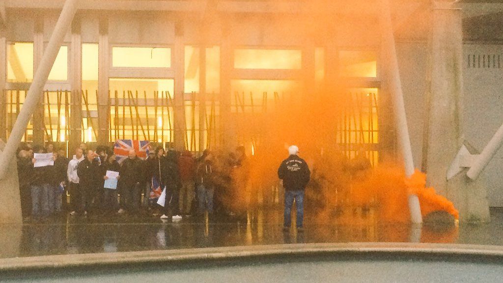 Smoke canister during fishermen's demonstration outside Scottish Parliament