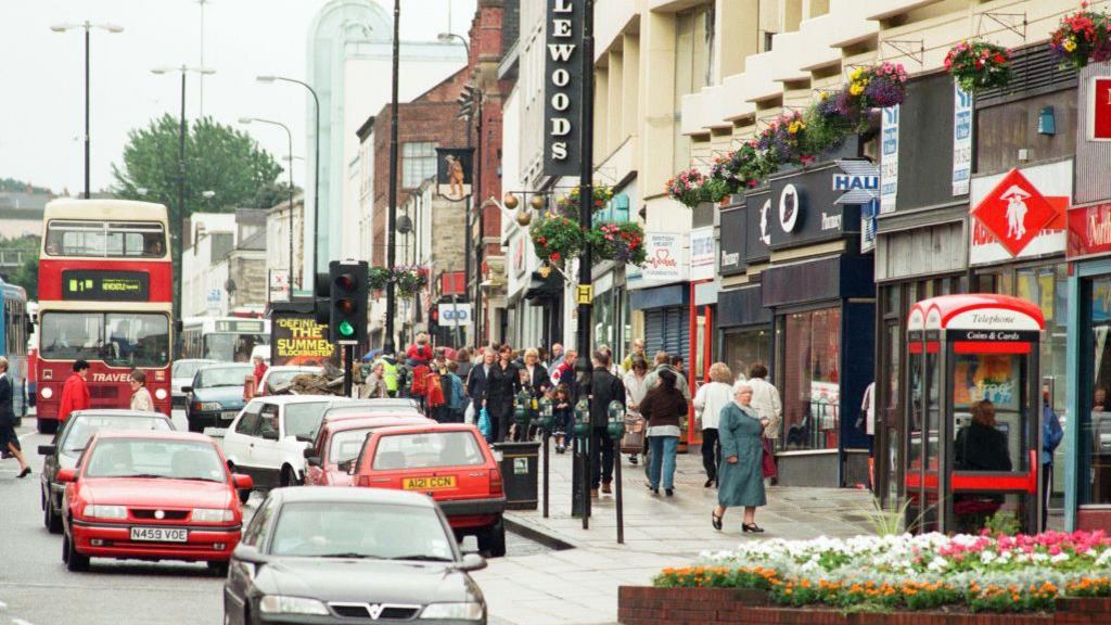 Gateshead High Street in August 1998 with shoppers and traffic. A Littlewoods shop sign can be seen