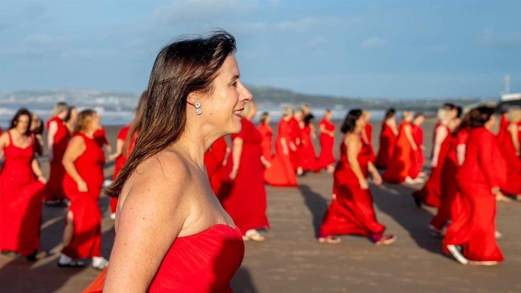 Cerys Llewellyn-Bevan, founder of Valley Rock Voices, with other choir members on the beach