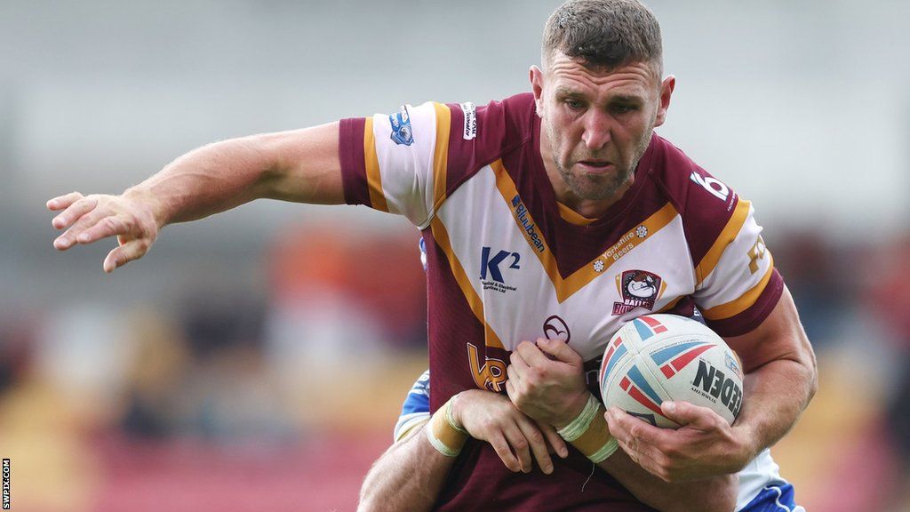 Batley's Dane Manning tussles with a Halifax tackler