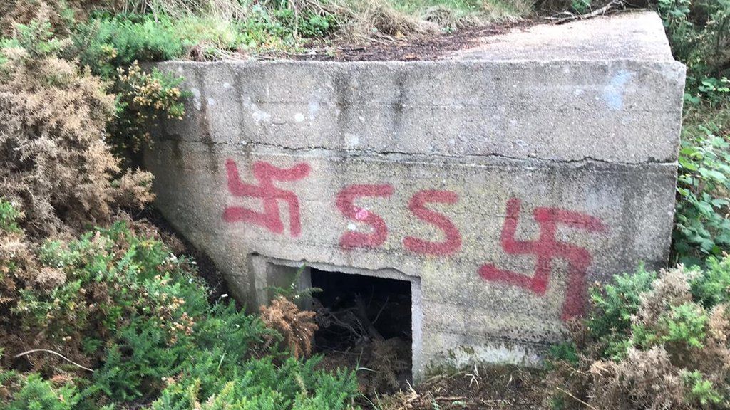 Swastika graffiti on a concrete bunker