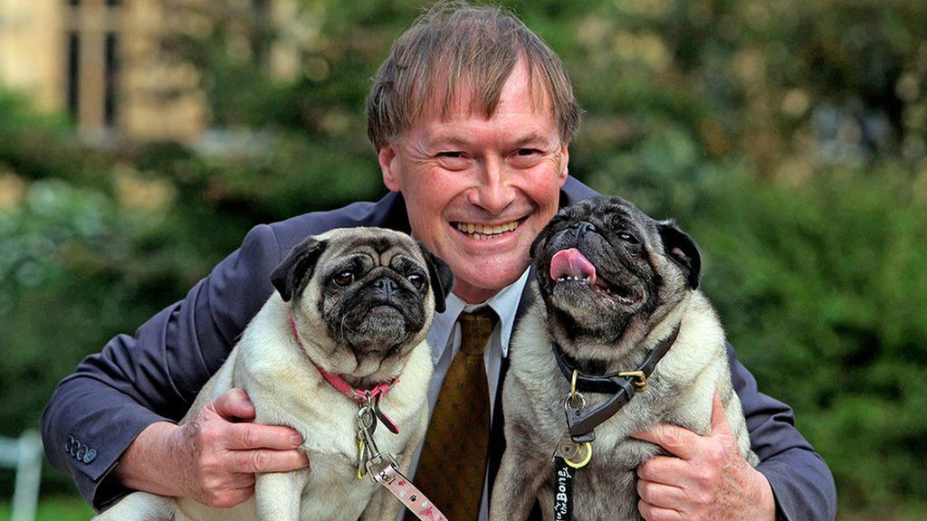 Conservative MP David Amess with his pugs, Lily and Boat at the Westminster Dog of the Year competition at Victoria Tower Gardens in London in October 2013
