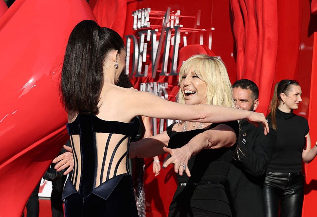 Anne Hathaway hugs Donatella Versace at the premiere. 