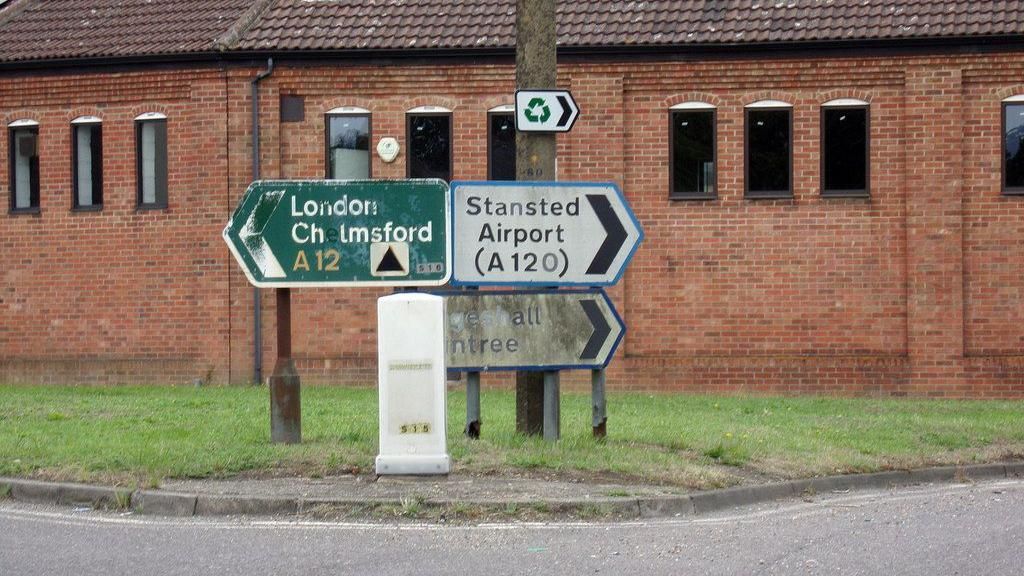 Road signs pointing towards the A12 and the A120 on the Prince of Wales roundabout