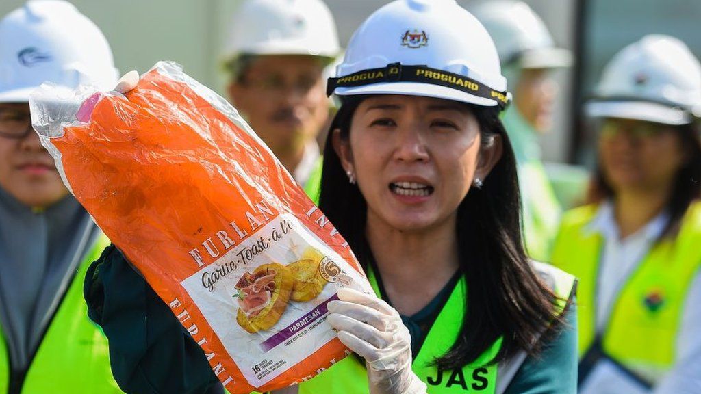Malaysia's Environment Minister Yeo Bee Yin shows a sample of plastic waste shipment before sending back to the country of origin in Port Klang, west of Kuala Lumpur on May 28, 2019.