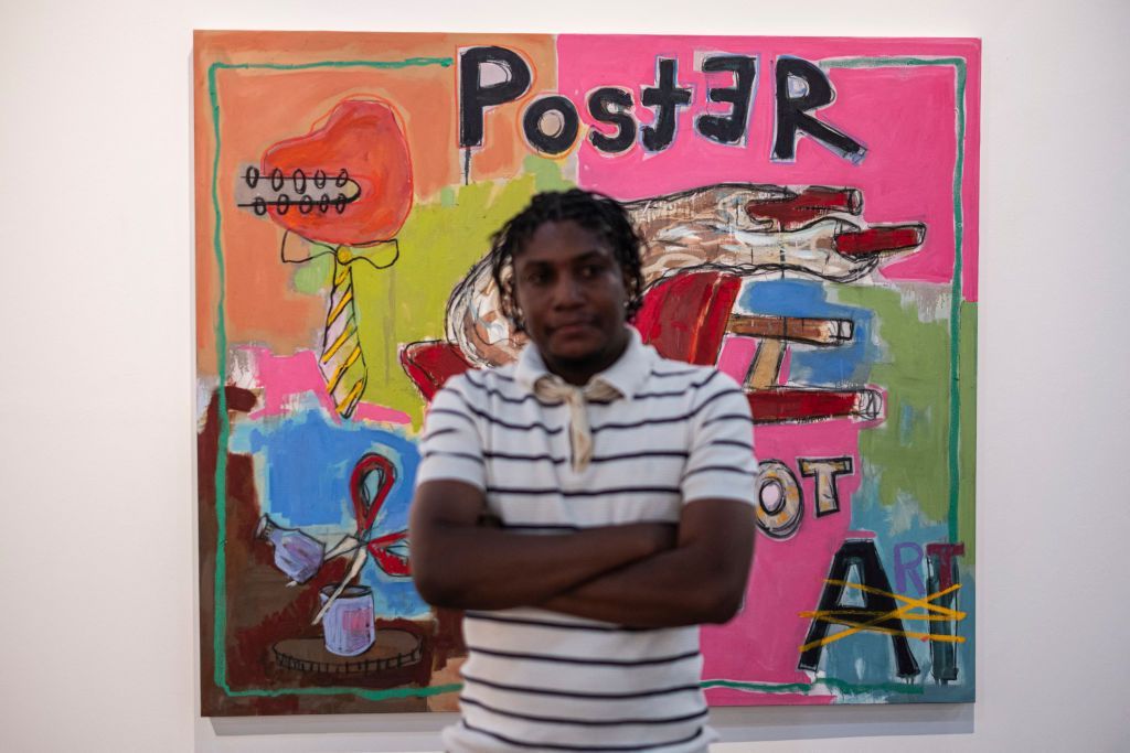 Zimbabwean painter Gresham Tapiwa Nyaude, winner of the 2024 FNB Art Prize, poses for a portrait in front of his painting at the FNB art fair in Sandton, near Johannesburg.