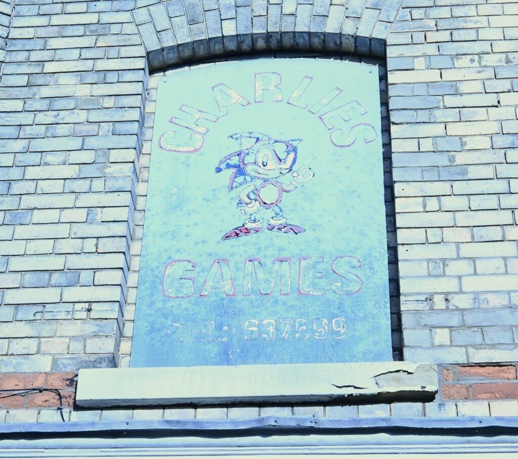 A faded coloured sign that says Charlie's Games with an image of the character Sonic