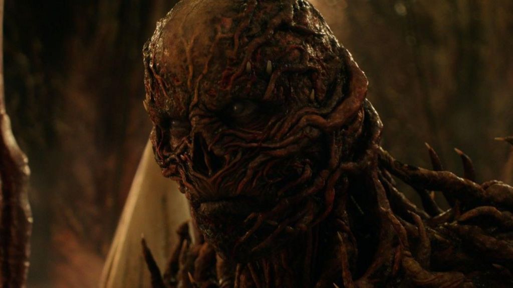 Vecna looking grim-faced - his face is made up of burned skin and spiky, red growths