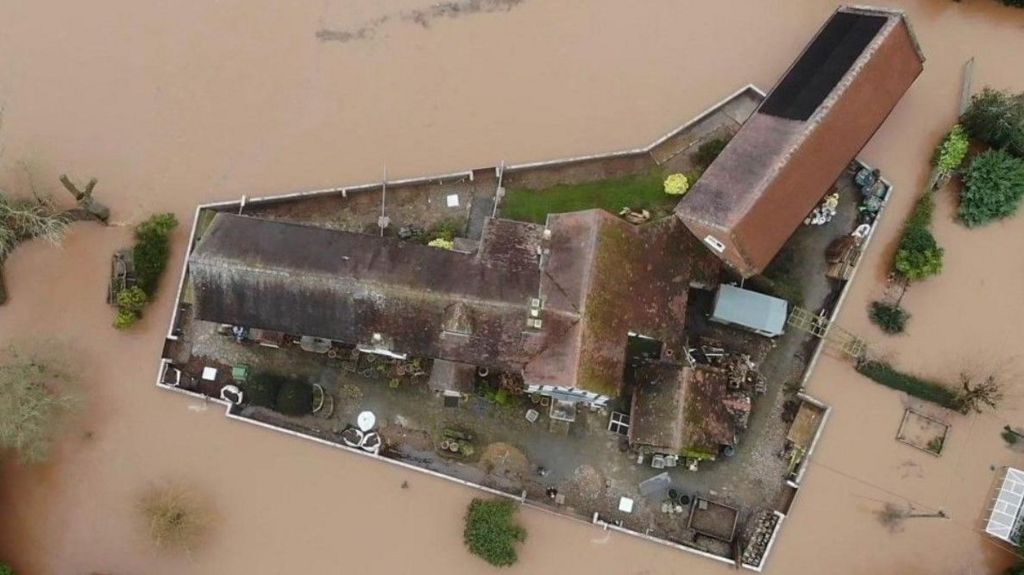 An aerial image showing a wall circling Nick Lupton's property, protecting it against floods, which cover the land beyond