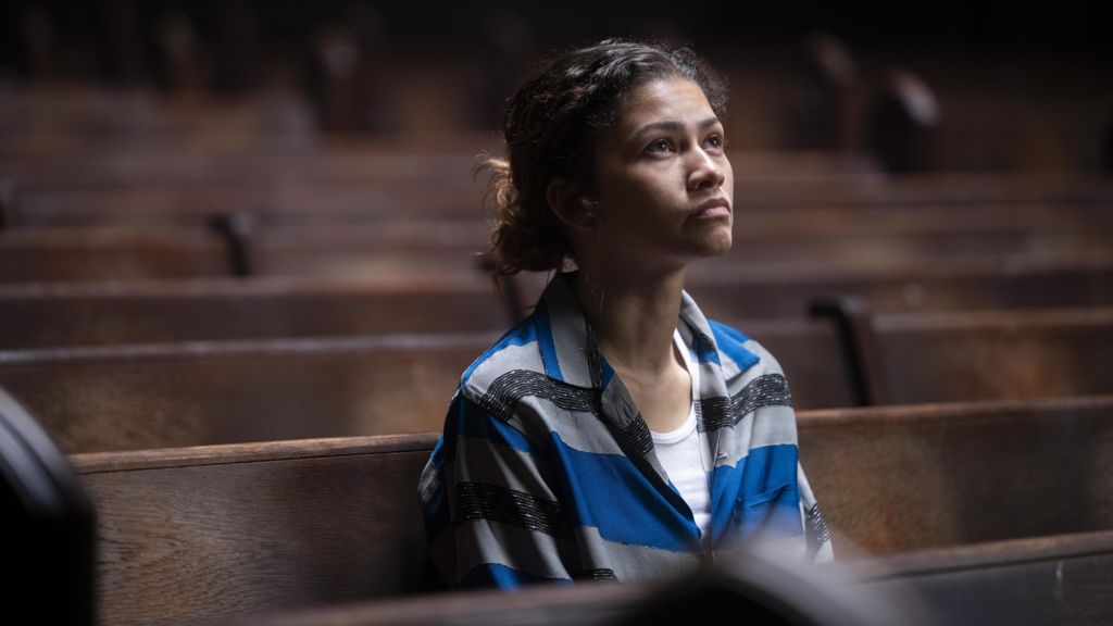Zendaya sitting in a church pew as Rue in a still from Euphoria