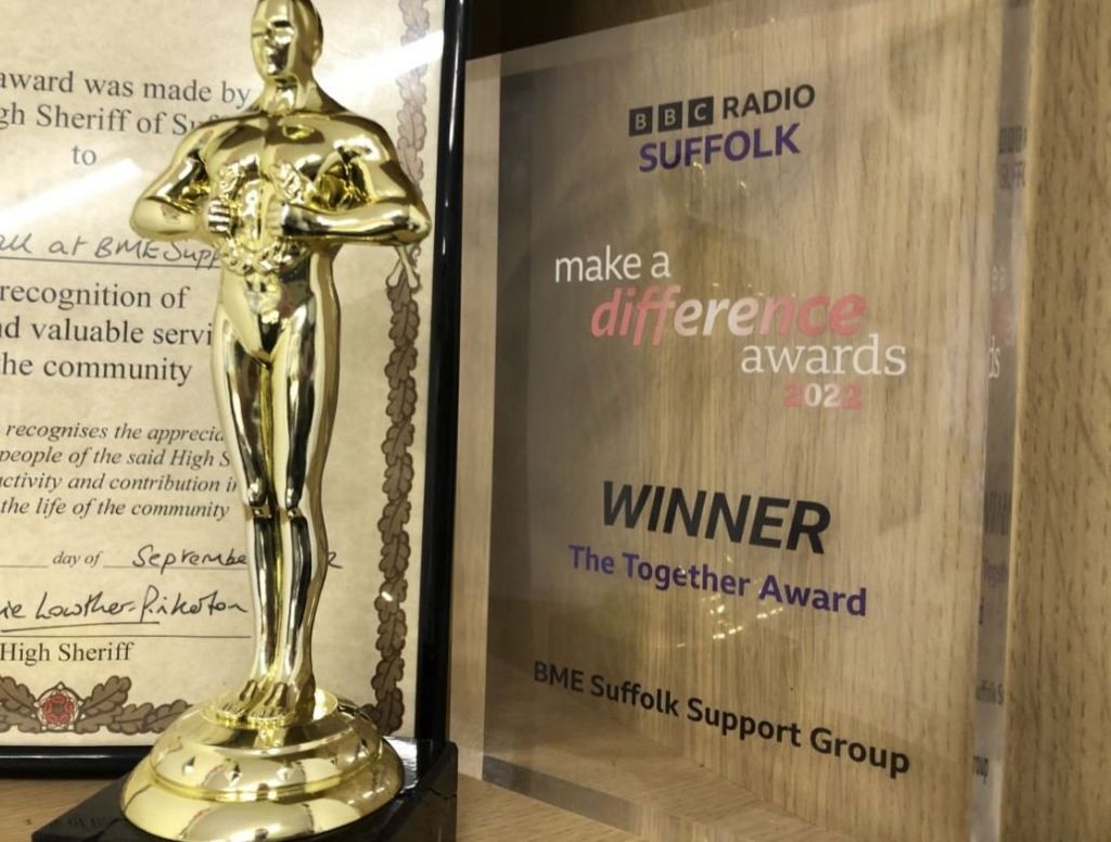 Accolades on the shelf won by BME Suffolk Support Group, including the glass BBC Make A Difference trophy