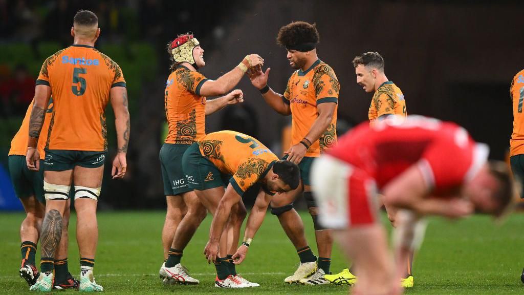 Australia players celebrate victory over Wales