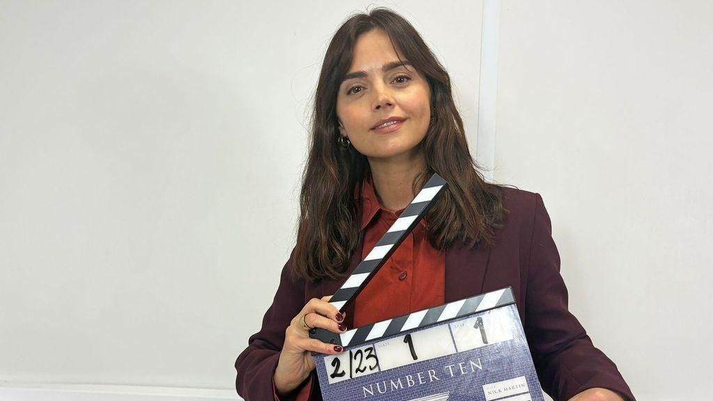 Jenna Coleman carrying a clapperboard for the Number 10 production