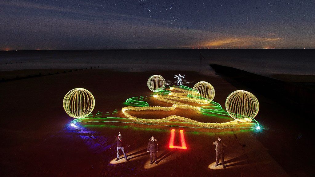 Light painting of Christmas tree and baubles on Frinton beach