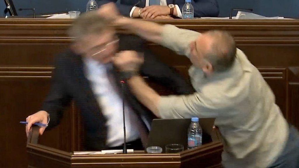 Man punching another man in parliament