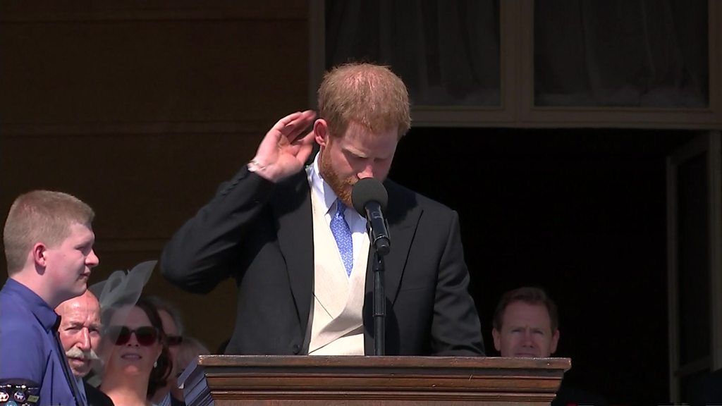 A bee distracts Prince Harry during his speech at a Buckingham Palace garden party.