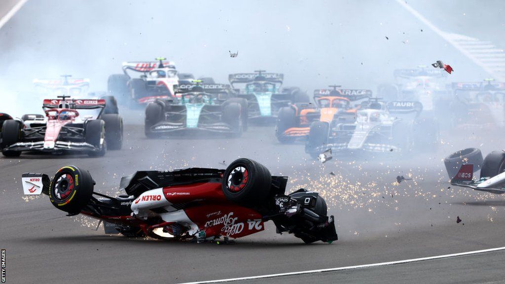 Zhou Guanyu suffers a big crash at Silverstone, skidding upside down in front of the rest of the field