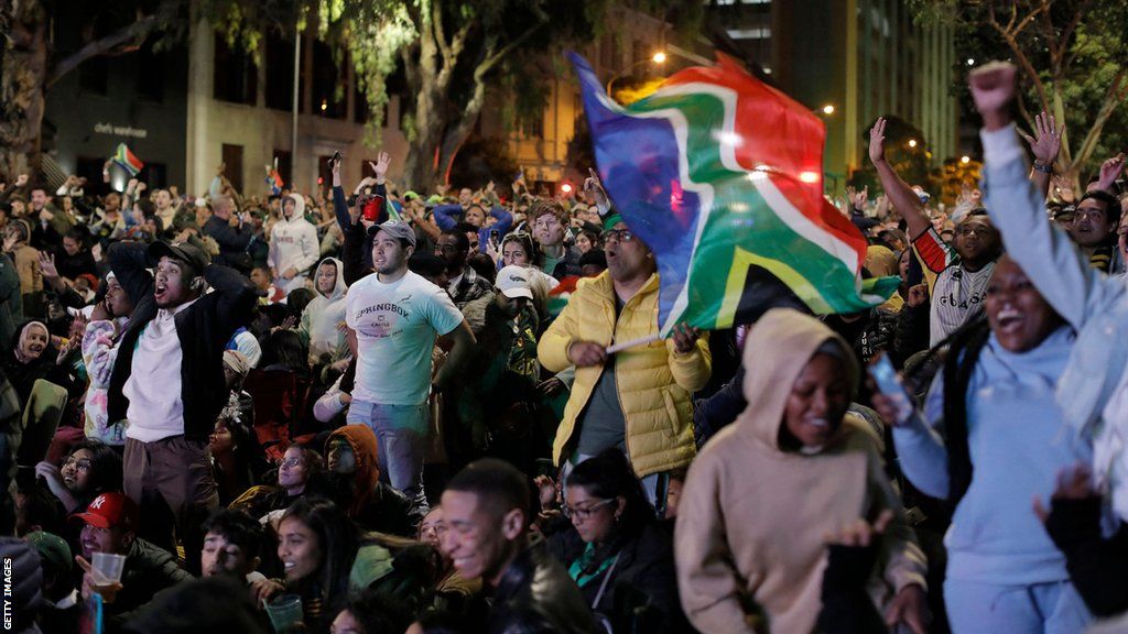 Huge numbers of people take to the streets in South Africa to watch the nation's rugby team beat New Zealand in the Rugby World Cup final