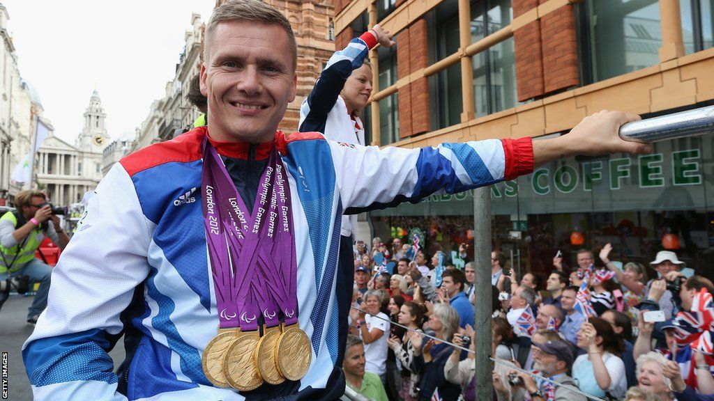 David Weir wearing his four gold medals, won at the London Paralympics, around his neck