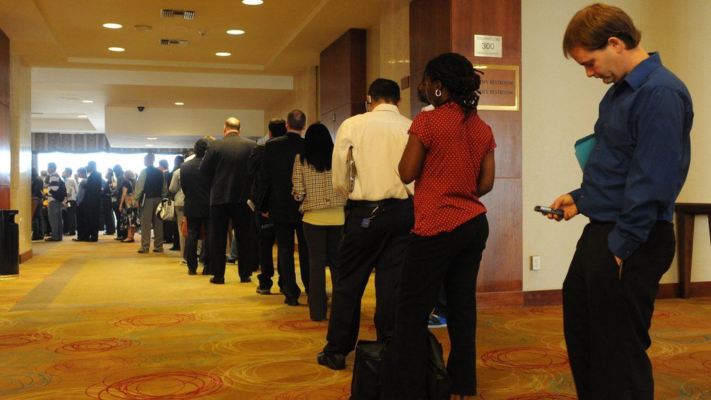 Unemployed Americans line up to speak with a prospective employers at a Los Angeles career fair