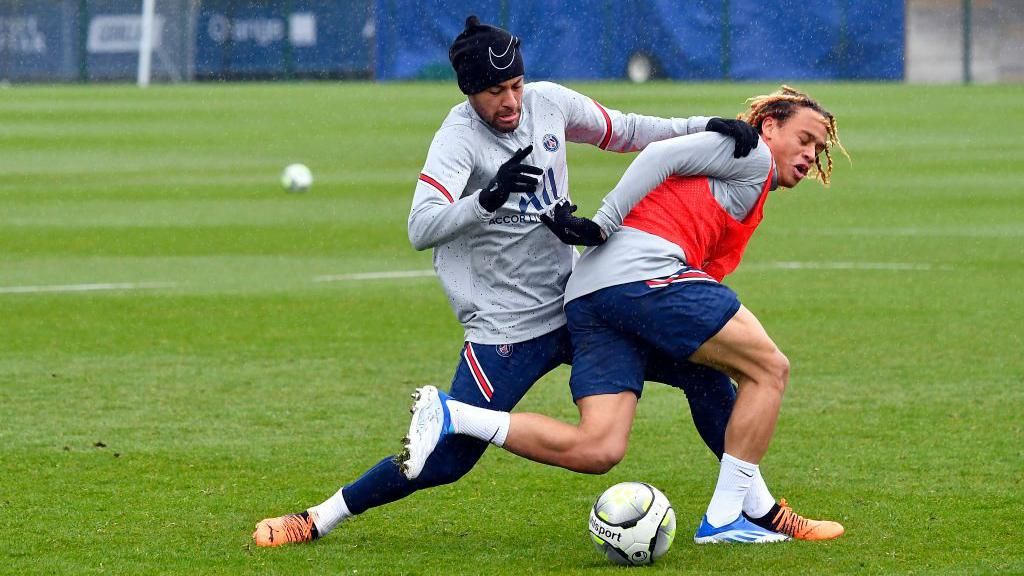 Xavi Simons is tackled by Neymar Jr in PSG training