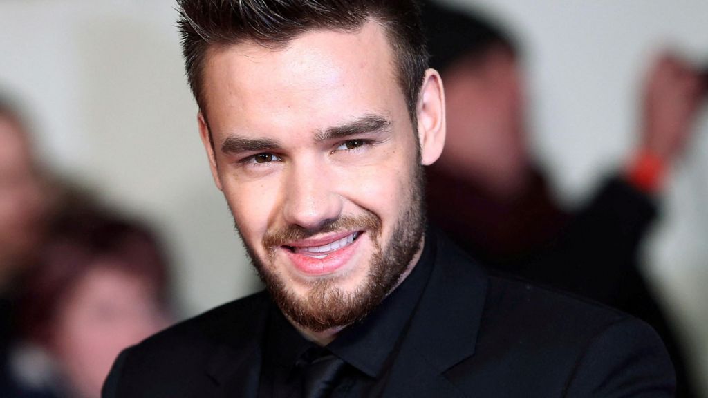 Liam Payne, dressed in black, smiling at a film premiere