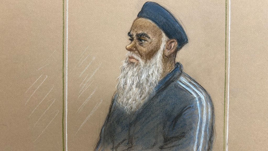 Court sketch shows a man in dock. He has a long, grey beard and is wearing a kufi
