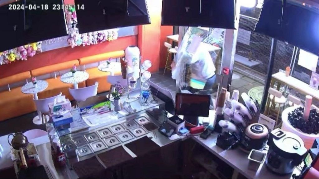 CCTV image of a burglar breaking into a shop in Bradford city centre