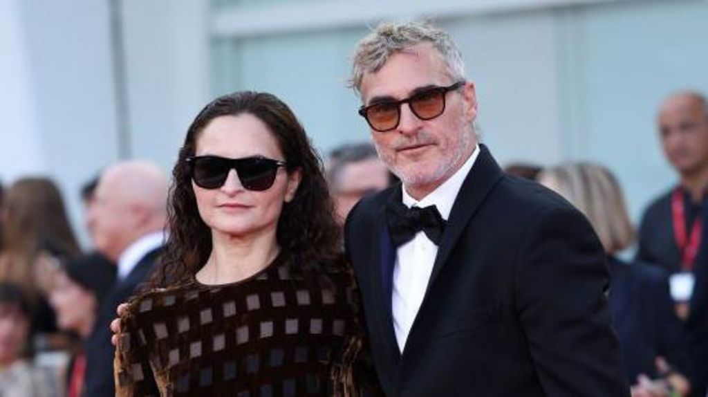 Rain Phoenix in dark glasses at the premiere with her brother Joaquin