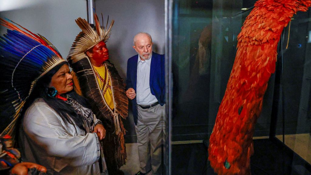 Brazil's President Luiz Lula da Silva accompanied by Sonia Guajajara, the Minister of Indigenous People, looks on at the Tupinamba cloak in Rio de Janiero