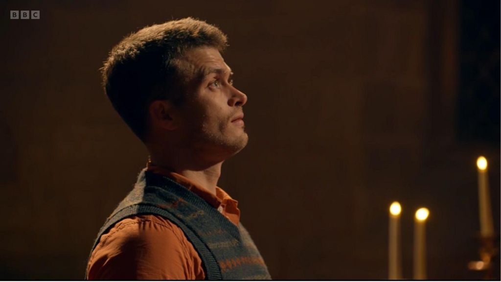 Matthew looking up in the church with candles in the background