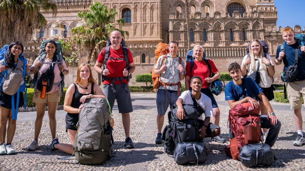 All 10 Race Across the World contestants, pictured outside Palermo Cathedral, lined up and ready to go with their backpacks on